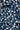 Close-up of the Panhandle Polo: Tropical Oasis, featuring a blue and white tropical leaf pattern and black and white buttons. The wrinkle-resistant fabric showcases overlapping leaves in vibrant blue shades.